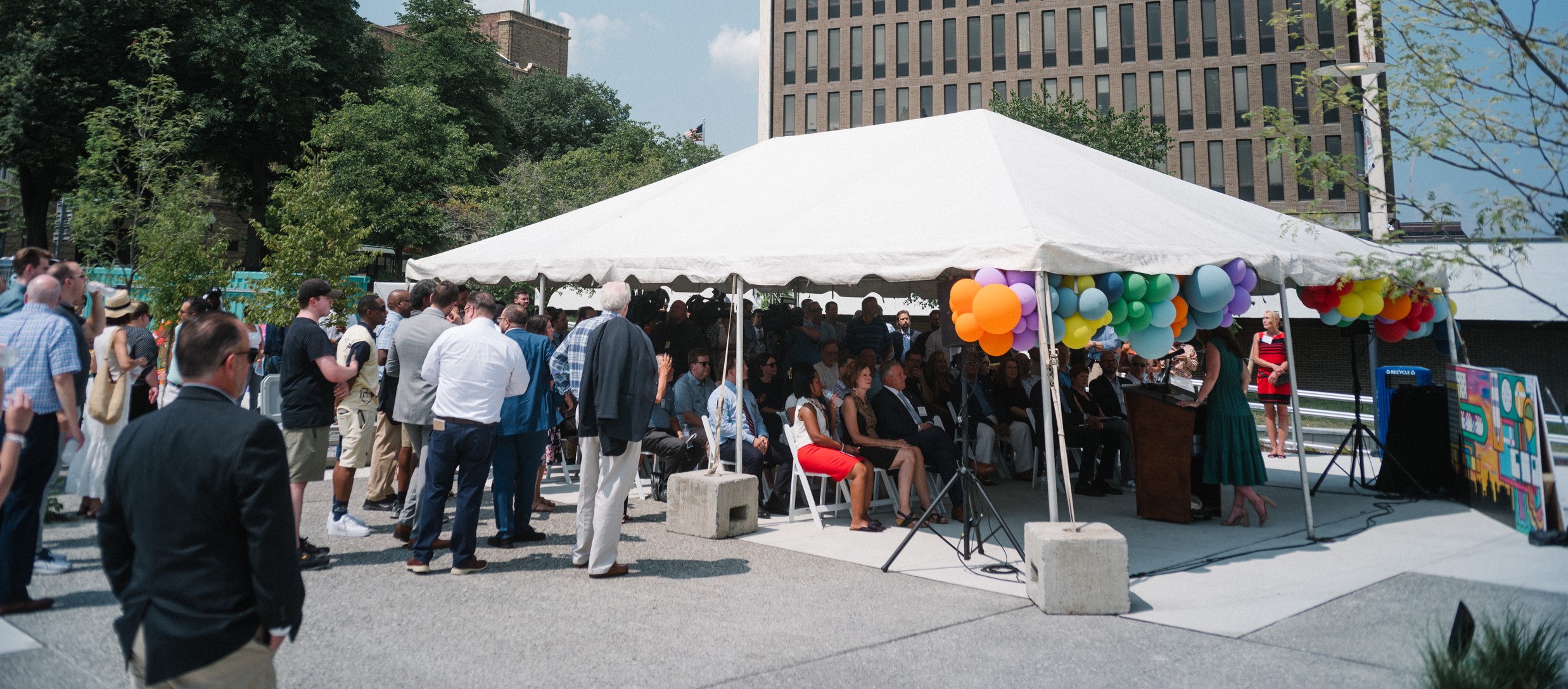 Photo of crowd and tent at Clinton Market Collective grand opening.