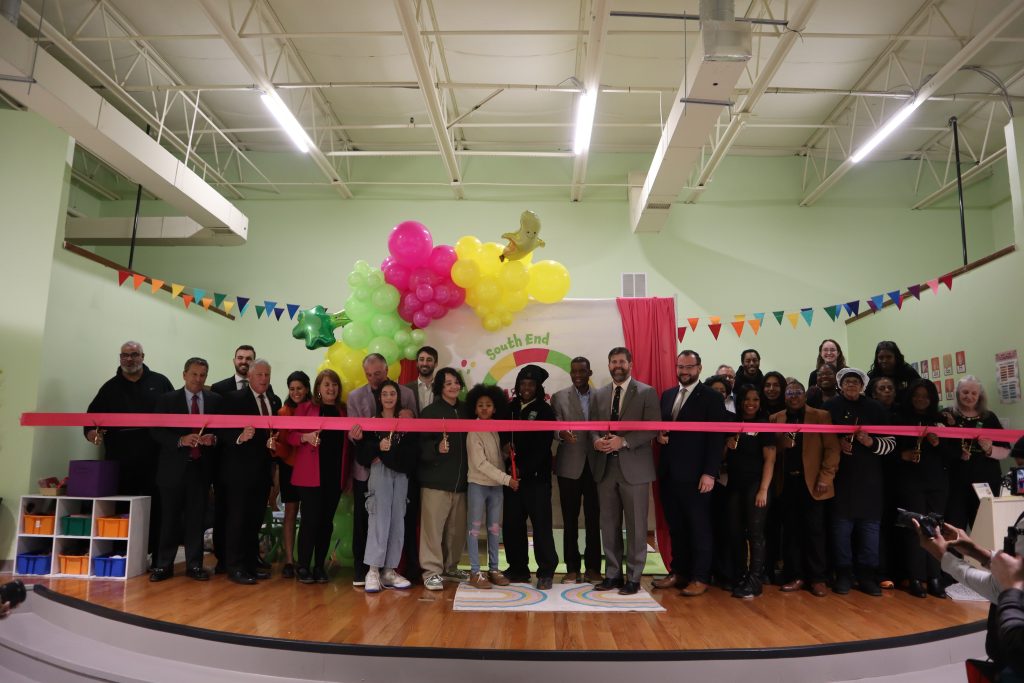 Cutting the ribbon for the grand opening of the new South End Children's Cafe 